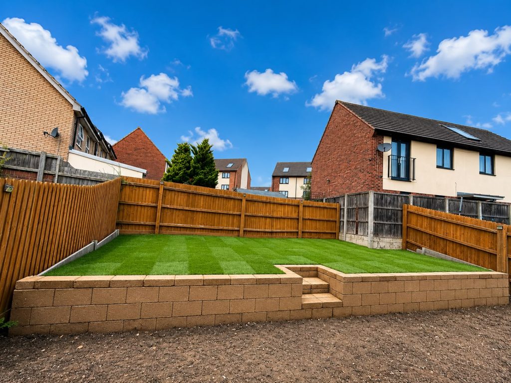 Landscaped garden with turf, timber fencing and retaining walls